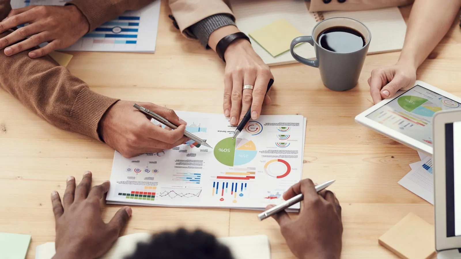 An advisor and business owner reviewing financial reports together